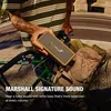 Marshall Emberton III portable Bluetooth speaker in Brown, held in one hand on a bike