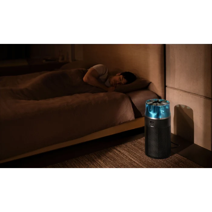 Dyson HushJet Compact HJ10 air purifier in Black/Teal, beside a bed at night