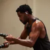 Beats Powerbeats Pro 2 true wireless earbuds in Hyper Purple, worn during a workout