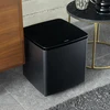 Bose Bass Module 700 wireless subwoofer in Black, on the floor beside a sideboard in a living room