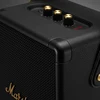 Marshall Tufton portable Bluetooth speaker in Black and Brass, close-up of the corner cap and metal grille