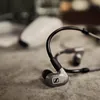Sennheiser IE 600 wired in-ear monitors, Silver, resting on a stone surface