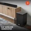 JBL Cinema SB180 2.1 soundbar with wireless subwoofer in Black, soundbar and 6.5-inch wireless subwoofer by a TV cabinet