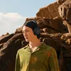 Sennheiser Accentum Wireless noise cancelling headphones in Black, worn outdoors by a man in a green shirt