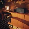 Marshall Stanmore III Bluetooth home speaker in Black, on a sideboard next to a record player