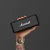 Marshall Emberton portable Bluetooth speaker in Black, held in one hand