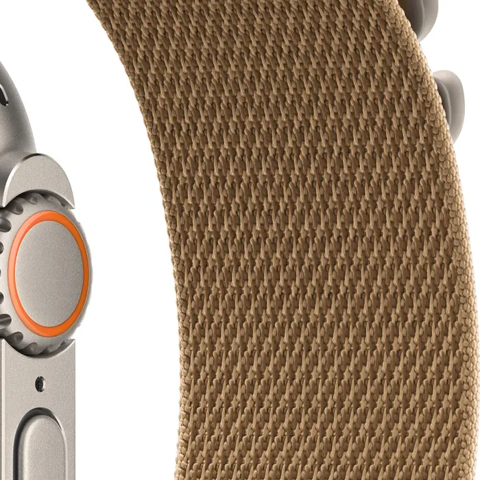 Apple Watch Ultra 4 in Natural Titanium with the Desert Alpine Loop, close-up of the Digital Crown, side button and woven strap