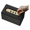 Marshall Acton III Bluetooth home speaker in Black, hand turning the volume knob