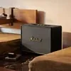 Marshall Woburn III Bluetooth home speaker in Black, beside a bed