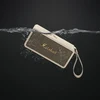 Marshall Middleton portable Bluetooth speaker in Cream, held under water