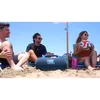 JBL Boombox 4 portable Bluetooth speaker in Blue, on a beach with friends