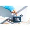 JBL Go 4 portable Bluetooth speaker in Blue, finger pressing the play button on top