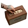 Marshall Acton III Bluetooth home speaker in Brown, hand turning the volume knob