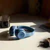 Beats Solo 4 on-ear wireless headphones in Slate Blue, on a table, lifestyle